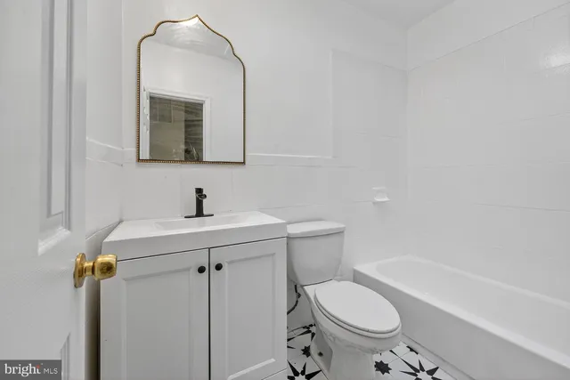 a bathroom with a sink toilet and a mirror