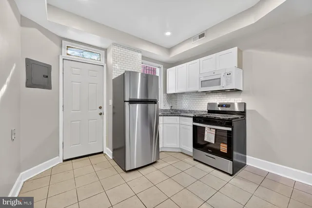 a kitchen with stainless steel appliances a refrigerator stove and sink