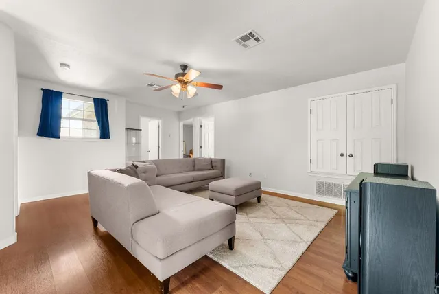 a bedroom with a bed a chandelier and a large window