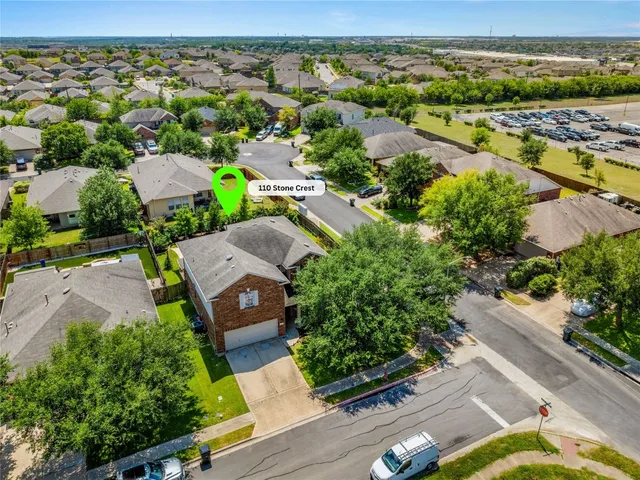 an aerial view of a house with a yard