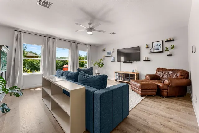 a kitchen with stainless steel appliances kitchen island granite countertop a stove a sink and a refrigerator