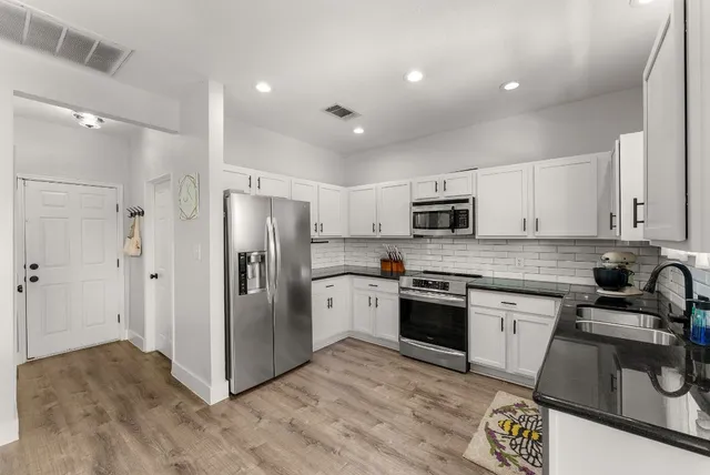 a large kitchen with a table and chairs in it