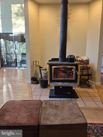 a living room with a fireplace cabinet and a table