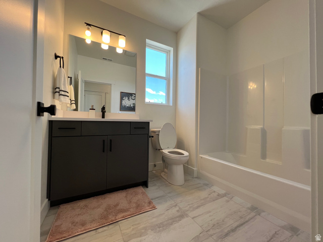 1951 2900 West Provo, UT 84601 - Photo 19 of 21 Bathroom featuring a dark wood-finish vanity with a light-toned countertop, a frameless mirror, and a three-light fixture