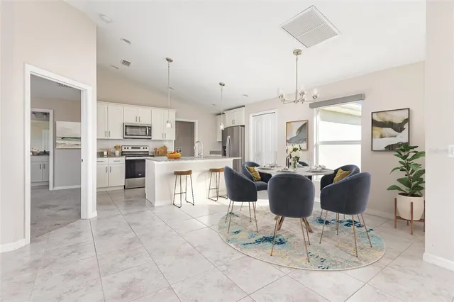 a living room with kitchen island furniture and a chandelier