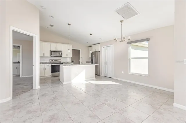a view of a kitchen with microwave and cabinets