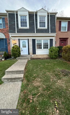 a front view of a residential apartment building with a yard