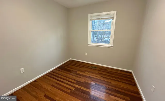 wooden floor and window in an empty room