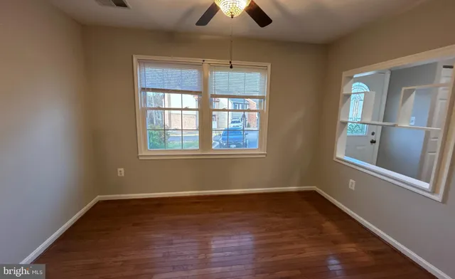 wooden floor in an empty room with a window