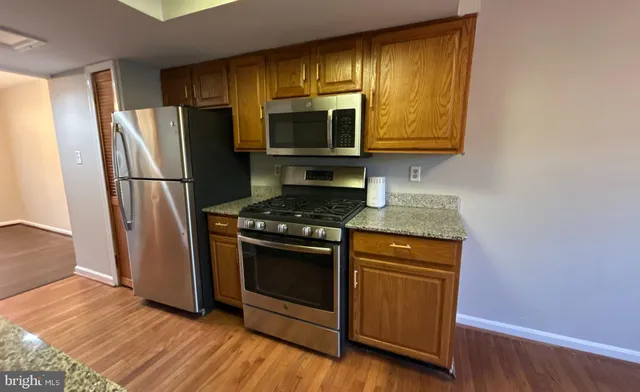 a kitchen with a refrigerator stove and microwave