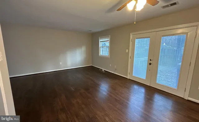 wooden floor in an empty room with a window