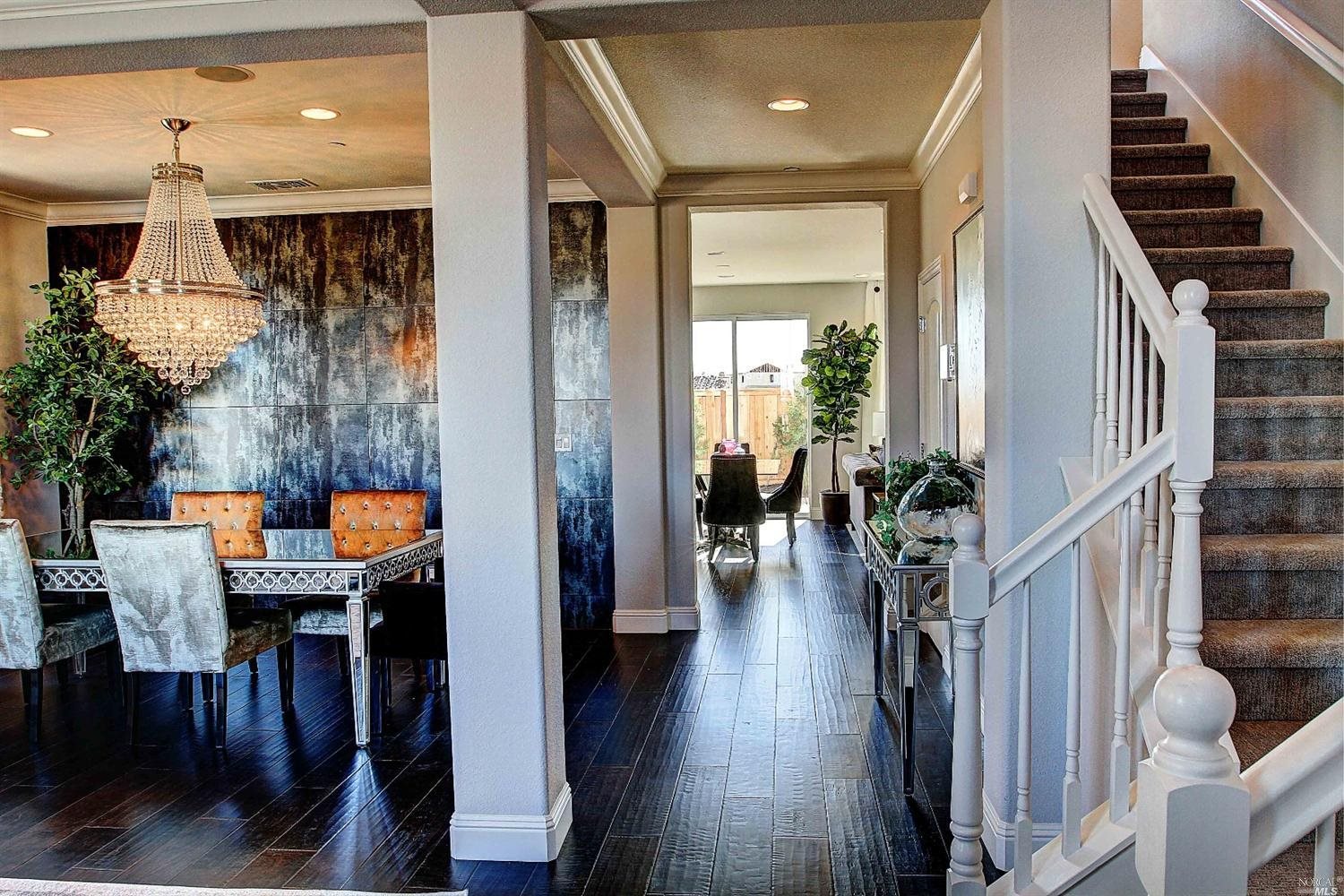 a dining room with furniture and wooden floor