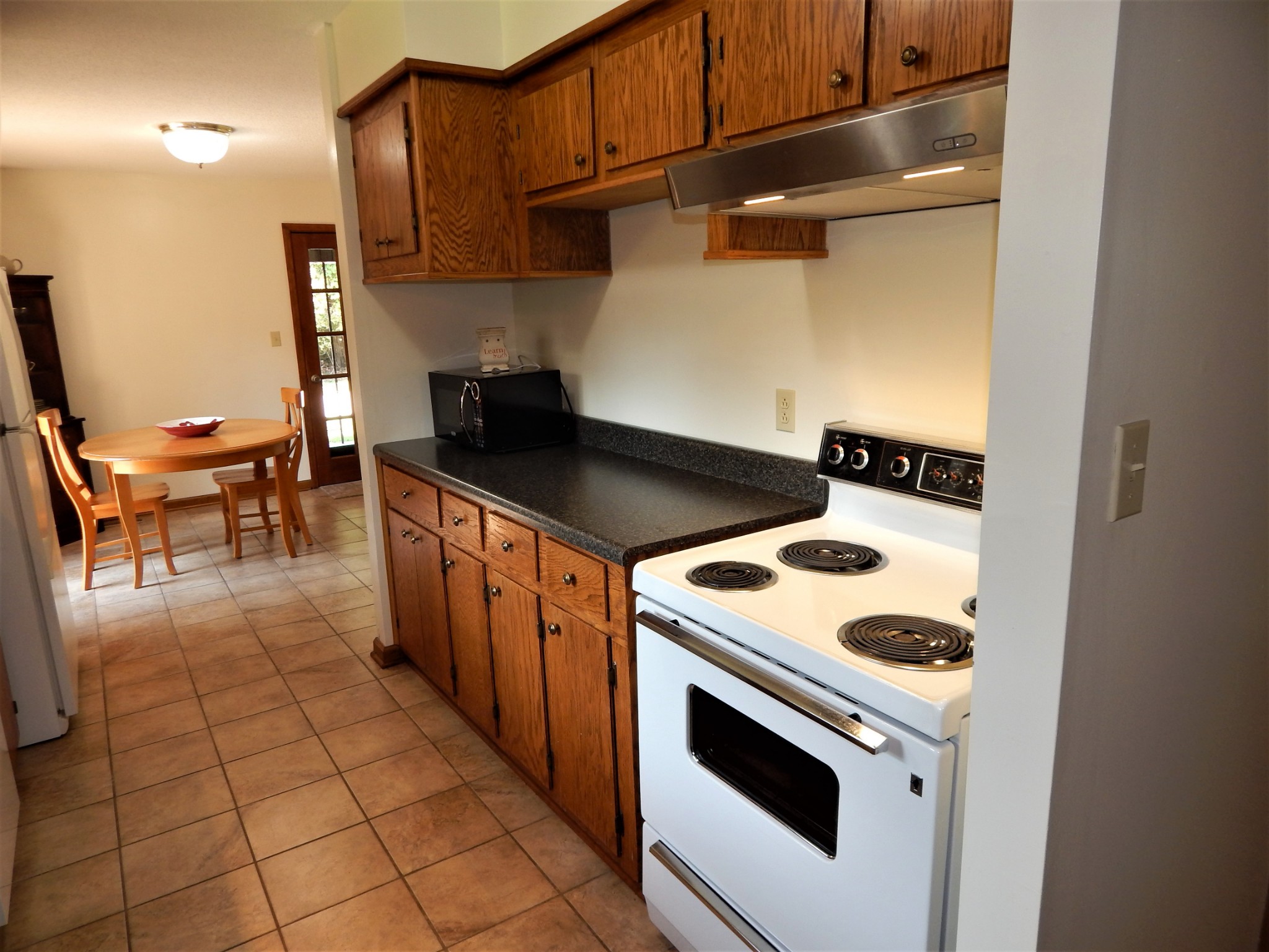 3753 Chisholm Road Iron City, TN 38463 - Photo 14 of 50 a kitchen with a stove and a refrigerator