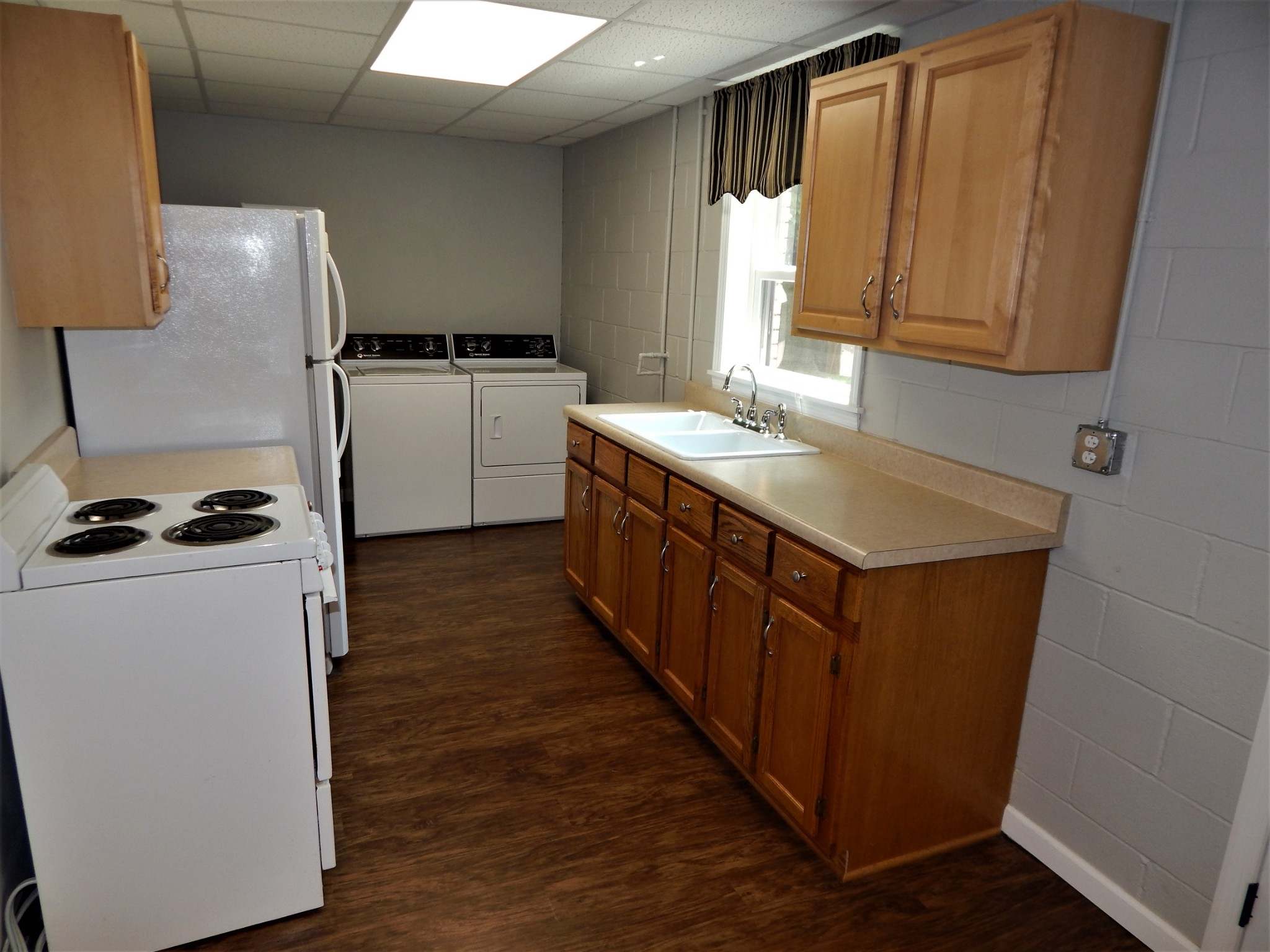 3753 Chisholm Road Iron City, TN 38463 - Photo 23 of 50 a kitchen with sink cabinets and a wooden floor