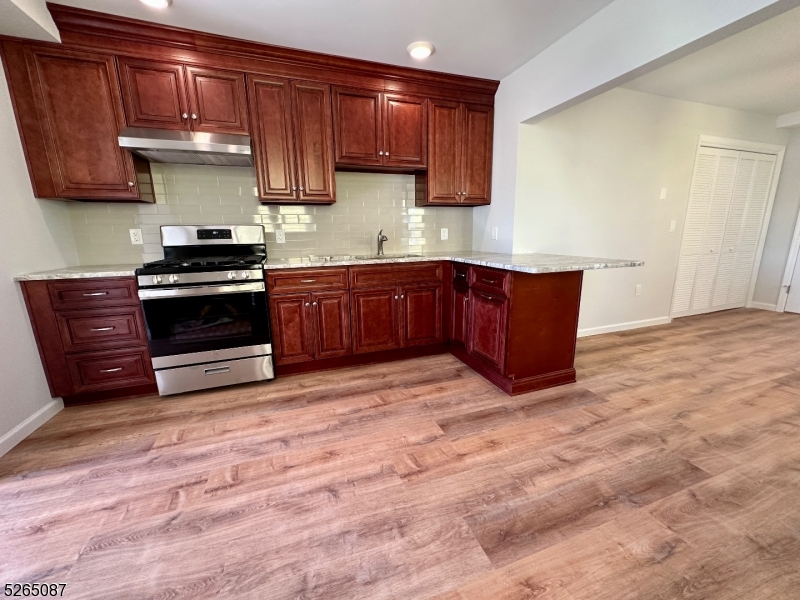 16 Colfax Street, Unit 4 Raritan, NJ 08869 - Photo 3 of 15 a kitchen with stainless steel appliances granite countertop a stove a sink and a microwave