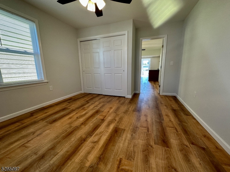 16 Colfax Street, Unit 4 Raritan, NJ 08869 - Photo 8 of 15 a view of an empty room with wooden floor and a window