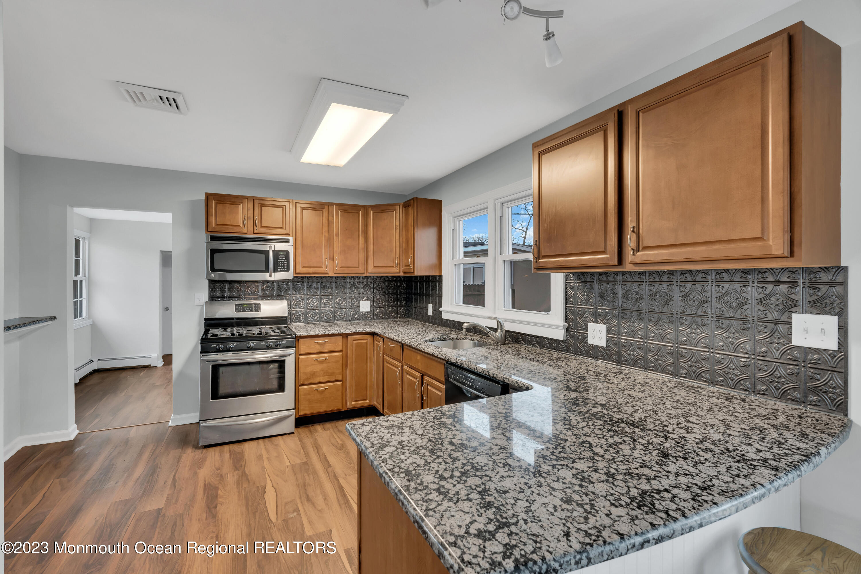 1007 Beaver Dam Road Point Pleasant, NJ 08742 - Photo 15 of 45 a kitchen with stainless steel appliances granite countertop a sink stove and refrigerator