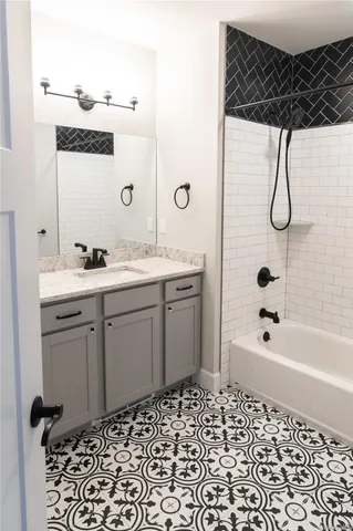 a bathroom with a bathtub a sink a vanity and a shower