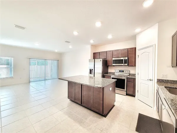 a kitchen with stainless steel appliances a stove refrigerator sink and cabinets
