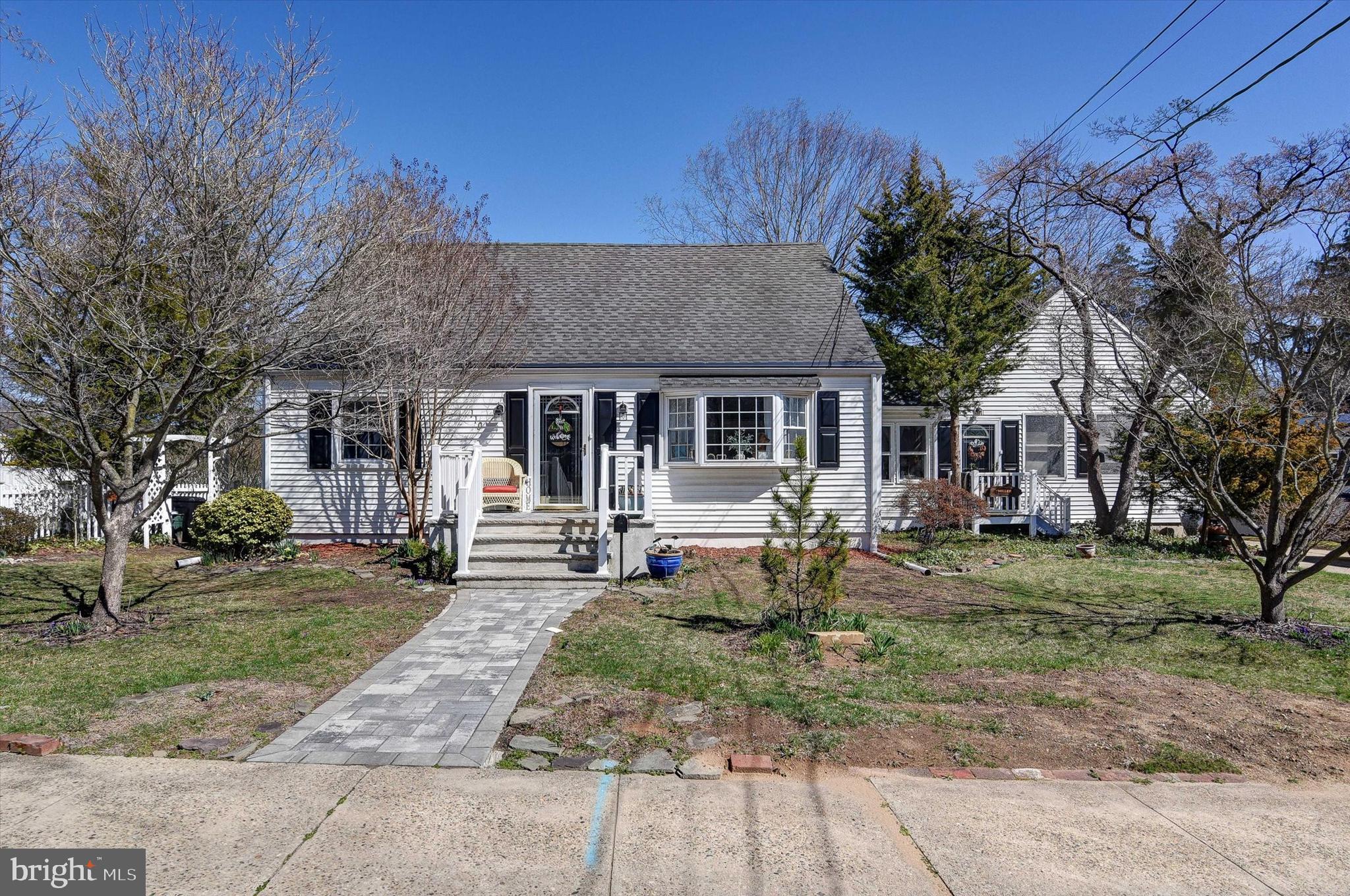 110 Natrona Avenue Hamilton, NJ 08619 - Photo 20 of 21 a front view of a house with a garden and trees