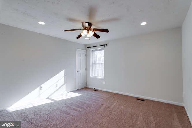 8610 Turkey Hill Road White Plains, MD 20695 - Photo 18 of 47 an empty room with windows and ceiling fan