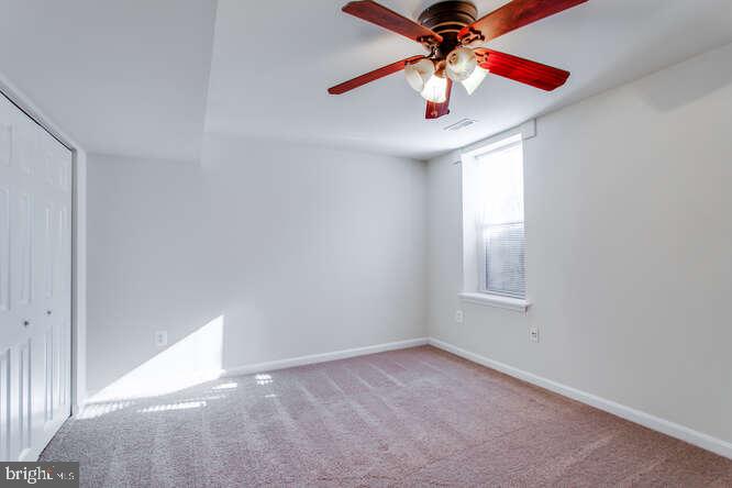 8610 Turkey Hill Road White Plains, MD 20695 - Photo 29 of 47 an empty room with a window and a fan