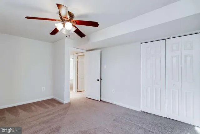 a view of a livingroom with a ceiling fan and window