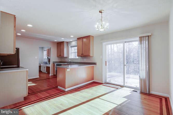 8610 Turkey Hill Road White Plains, MD 20695 - Photo 5 of 47 a kitchen with stainless steel appliances granite countertop a refrigerator a sink dishwasher a stove and white cabinets with wooden floor