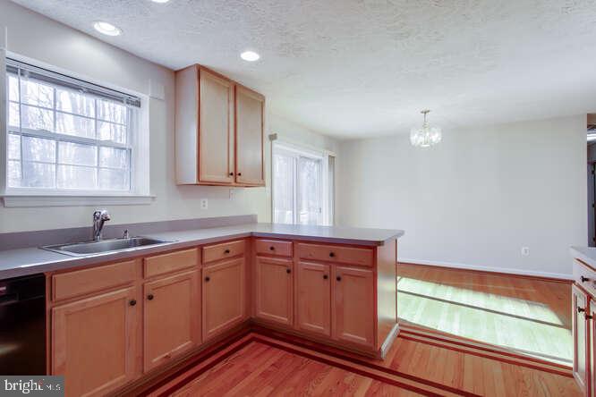 8610 Turkey Hill Road White Plains, MD 20695 - Photo 7 of 47 a kitchen with sink cabinets and wooden floor