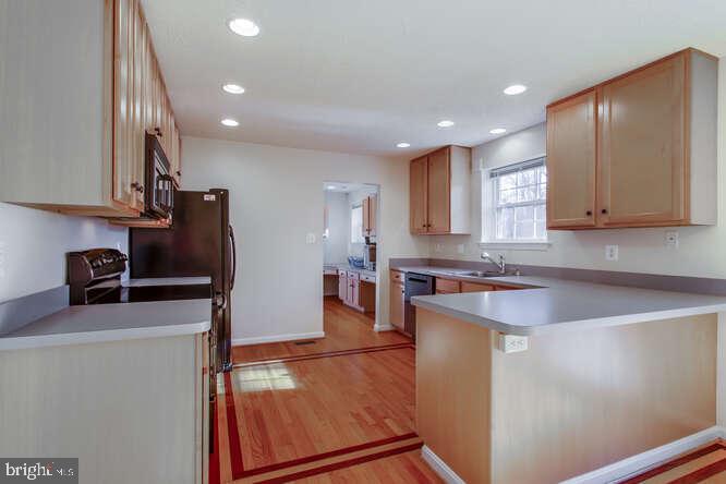 8610 Turkey Hill Road White Plains, MD 20695 - Photo 9 of 47 a kitchen with stainless steel appliances granite countertop a sink stove and refrigerator