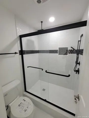 a bathroom with a shower and a sink