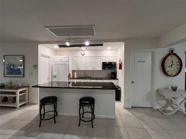a kitchen with stainless steel appliances a stove and cabinets