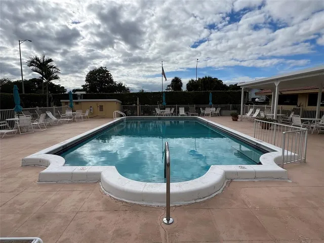 a view of a swimming pool with seating space