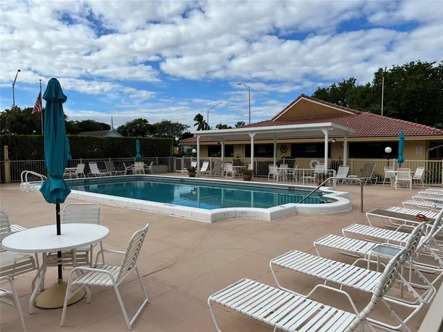 a view of a patio with swimming pool table and chairs
