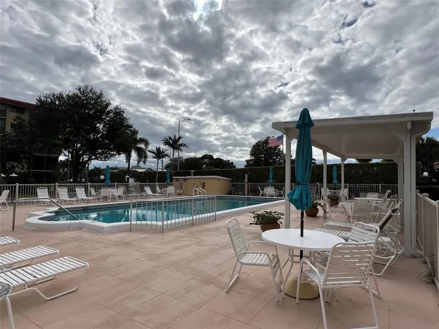 a patio with a yard table and chairs