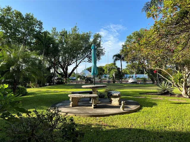 a view of a house with swimming pool and a big yard
