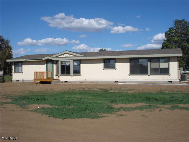 a front view of a house with a garden and yard