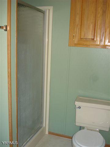 100 Martin Road Toppenish, WA 98948 - Photo 13 of 14 a white toilet sitting next to a shower