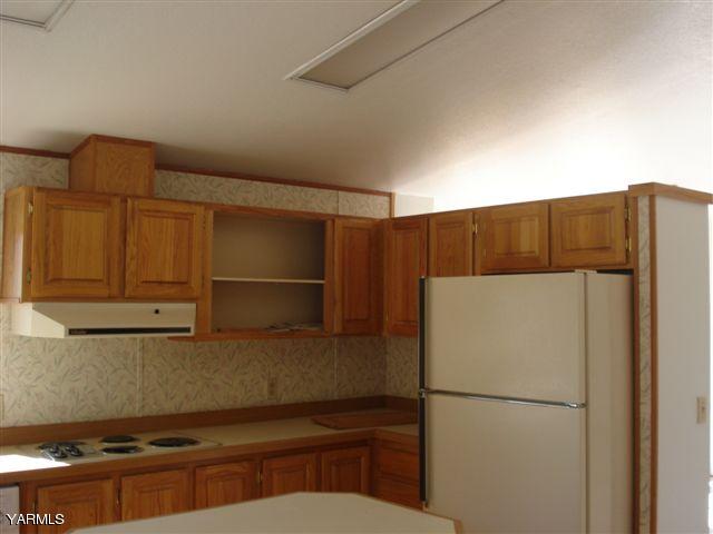 100 Martin Road Toppenish, WA 98948 - Photo 9 of 14 a kitchen with a refrigerator and a stove