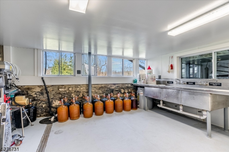 25 Clove Road Wantage, NJ 07461 - Photo 34 of 49 a bathroom with blue countertop and a bathtub