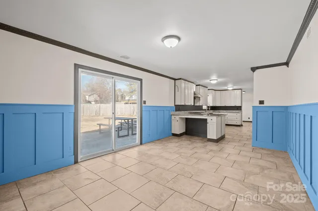 a view of kitchen with refrigerator and cabinets