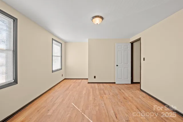 a bathroom with a granite countertop sink toilet and a mirror