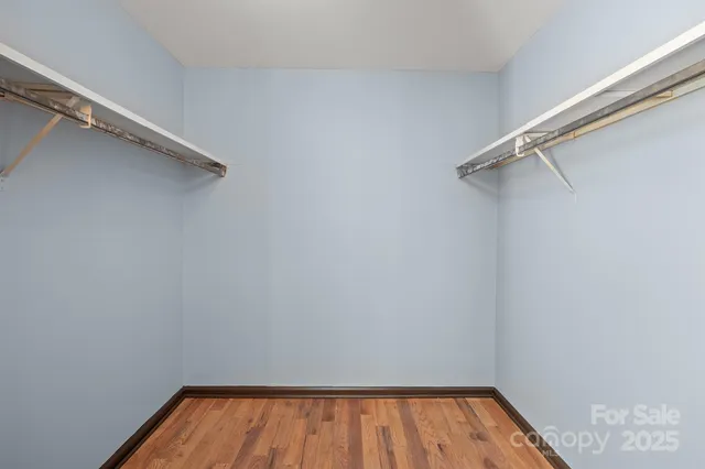 a bathroom with a sink a mirror a toilet and a window