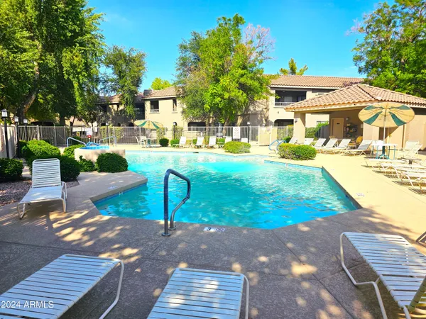 a view of a patio with couches table and chairs and potted plants