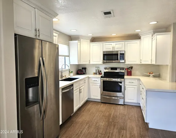 a kitchen with a refrigerator stove and microwave