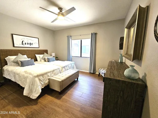 a bedroom with a bed and a flat screen tv