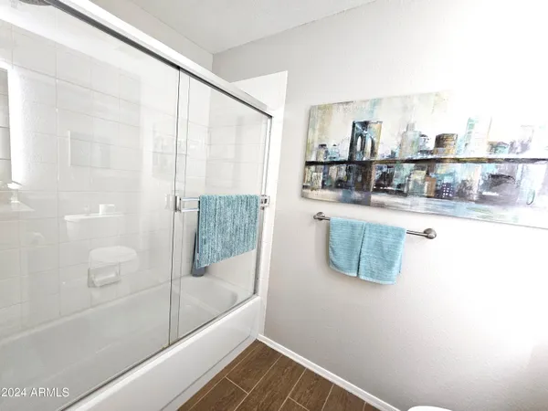 a bathroom with a bathtub and a shower
