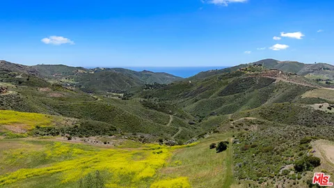 a view of an ocean and mountains