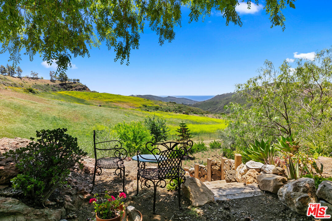 12470 Yerba Buena Road Malibu, CA 90265 - Photo 8 of 17 a view of a lake with a garden