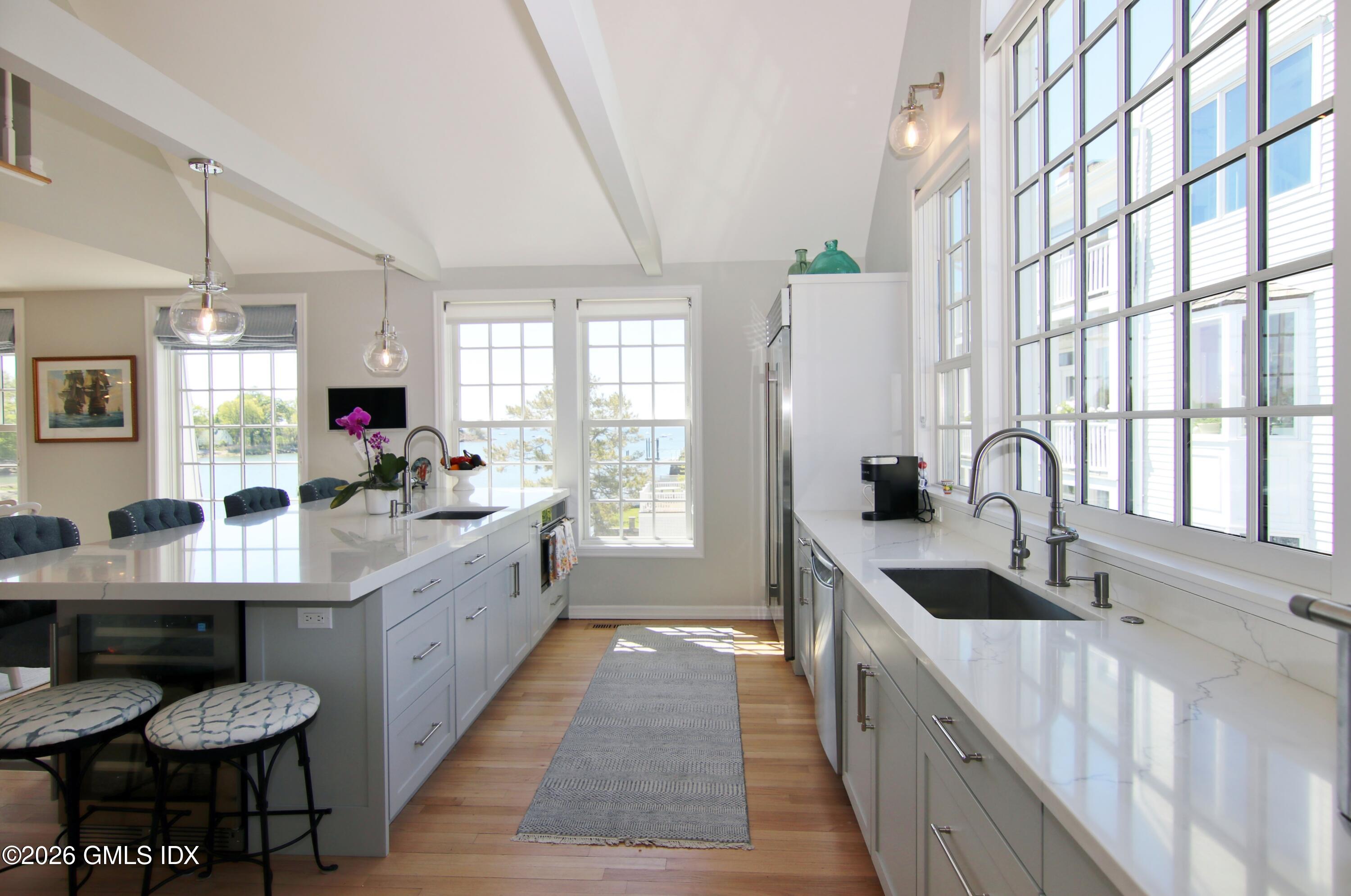 633 Steamboat Road, Unit 5 Greenwich, CT 06830 - Photo 18 of 29 a large kitchen with kitchen island granite countertop a sink and cabinets